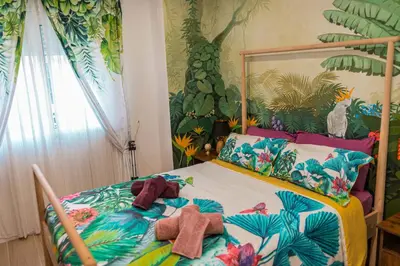 a bedroom with a bed with stuffed animals on it at Artistic flat next to Ruzafa Welcome to the Jungle in Valencia