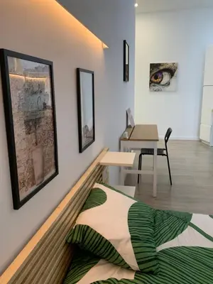 a living room with a bed and a table at Luna y Sol in Valencia