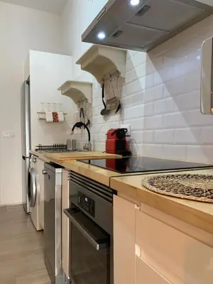 a kitchen with a stove top oven next to a refrigerator at Luna y Sol in Valencia