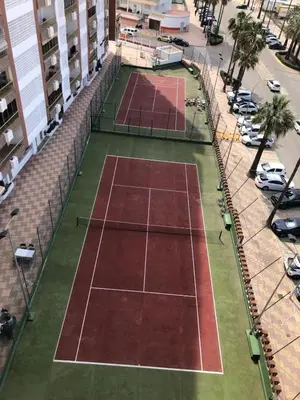 an overhead view of two tennis courts on a city street at Apartamento ARENSOL EN PRIMERA LINEA DE PLAYA in Cullera