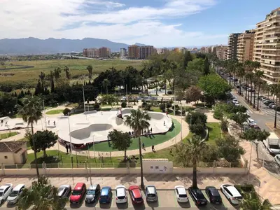 a parking lot with parked cars and a skate park at Apartamento ARENSOL EN PRIMERA LINEA DE PLAYA in Cullera