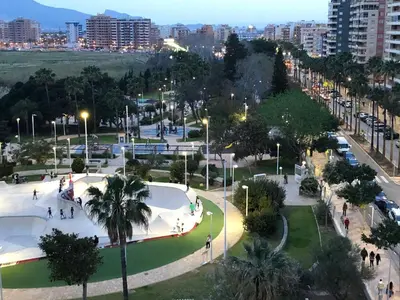 a park with a skate park in a city at night at Apartamento ARENSOL EN PRIMERA LINEA DE PLAYA in Cullera