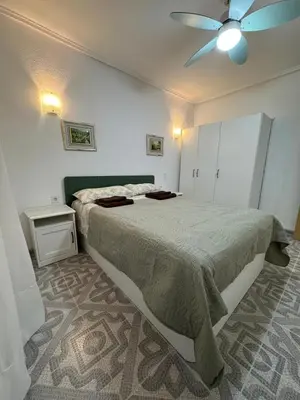 a bedroom with a bed and a ceiling fan at Apartamento en Cullera in Cullera