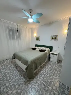 a bedroom with a bed and a ceiling fan at Apartamento en Cullera in Cullera