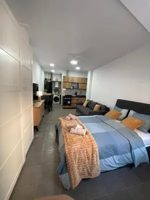 a bedroom with a bed and a living room at UIM Mediterraneo Estudio PB San Jose Wifi in Puerto de Sagunto