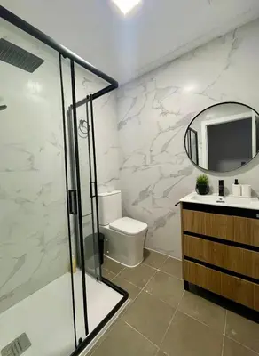 a bathroom with a shower and a toilet and a mirror at UIM Mediterraneo Estudio PB San Jose Wifi in Puerto de Sagunto