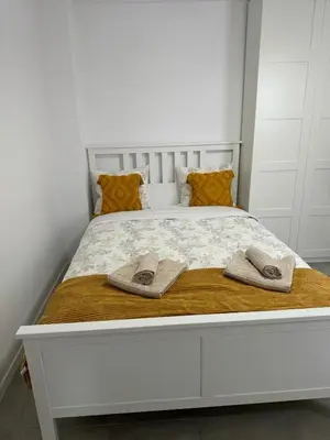 a large white bed with two towels on it at UIM Mediterraneo PB Cendoya 1 wifi in Puerto de Sagunto