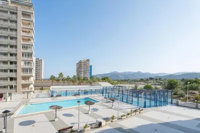 a swimming pool in a city with buildings at Relájate en pareja o familia!!! in Tavernes de Valldigna