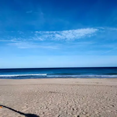 a sandy beach with the ocean in the background at Modern Apartment Frontline Beach in Mareny Blau