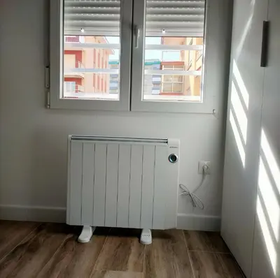 a white radiator in a room with two windows at Modern Apartment Frontline Beach in Mareny Blau