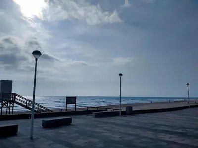 a pier with two street lights and the ocean at Modern Apartment Frontline Beach in Mareny Blau