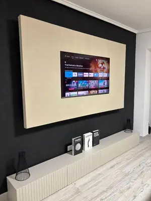 a large screen tv on a black wall at SuecaRoom Prime Experience in Sueca