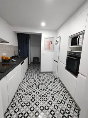 a kitchen with a black and white tiled floor at SuecaRoom Prime Experience in Sueca