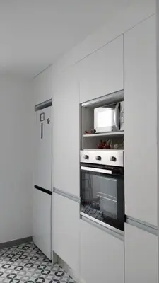a kitchen with white cabinets and an oven at SuecaRoom Prime Experience in Sueca