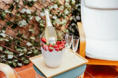 a bottle of champagne and strawberries on a table with glasses at Casa Pancho, ChillOut, Oceanographic, City of Arts in Valencia