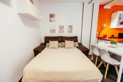 a bedroom with a bed and a table with chairs at Casa Pancho, ChillOut, Oceanographic, City of Arts in Valencia