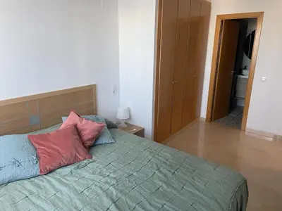 a bedroom with a bed with two pillows on it at Excelente ático con gran terraza y barbacoa en Canet d'en Berenguer in Valencia