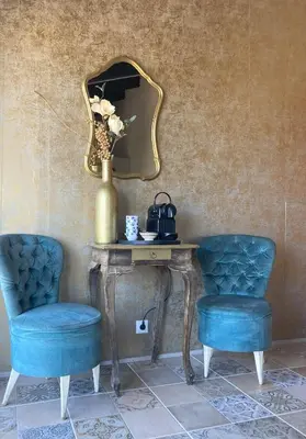 two blue chairs sitting next to a table with a mirror at Villa Torre Macastre, Valencia in Macastre