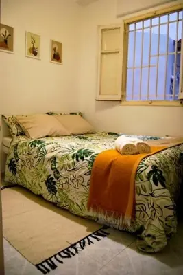 a bedroom with a bed with a blanket on it at Habitación céntrica in Valencia