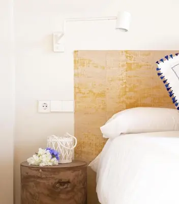 a bedroom with a bed and a table with flowers at Hotel Rural El Teular in Sueca