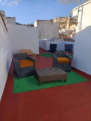 a room with chairs and tables on a roof at El Molino Buñol Apartamento in Buñol