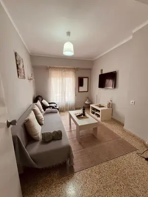 a living room with a couch and a table at El Molino Buñol Apartamento in Buñol