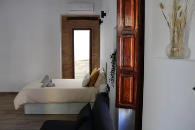a black table and chairs in a room with a door at Las Arenas Suites 1 PLAYA in Valencia