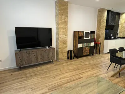 a living room with a flat screen tv on a entertainment center at Valdeolivas Suites in Valencia