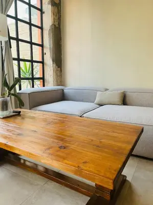 a living room with a couch and a wooden coffee table at Loft a 5min de la playa in Valencia