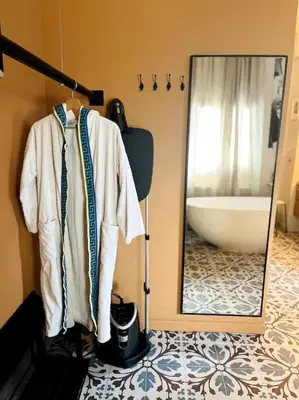 a bathroom with a mirror and a bath tub at Loft a 5min de la playa in Valencia