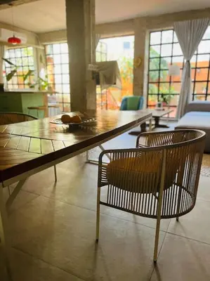 a living room with a large wooden table and chairs at Loft a 5min de la playa in Valencia