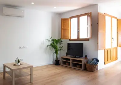 a living room with a tv and a table at Mar de fonts ain in Ahín
