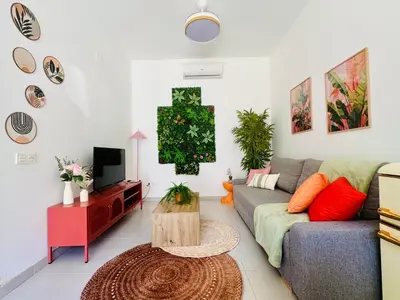 a living room with a couch and a tv at Sweet Aparment in Russafa (Soho) in Valencia