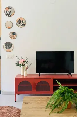 a living room with a red entertainment center with a flat screen tv at Sweet Aparment in Russafa (Soho) in Valencia