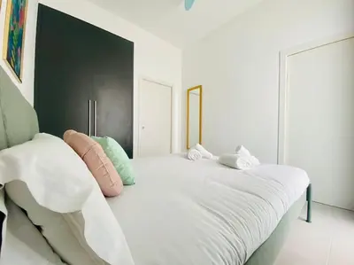 a bedroom with a large white bed with pillows at Sweet Aparment in Russafa (Soho) in Valencia