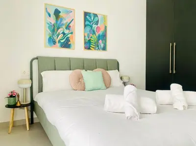 a large white bed with pillows on top of it at Sweet Aparment in Russafa (Soho) in Valencia