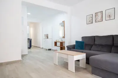 a living room with a couch and a coffee table at El hogar del mar. in Sueca
