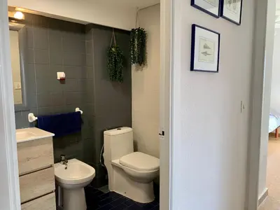a bathroom with a toilet and a sink at Big Gran Khan Apartment Canet den Berenguer con Piscina in Canet de Berenguer