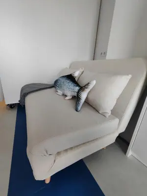 a couch with two pillows and a fish on it at CariSan2 - fully equipped, 6 min to beach in Valencia