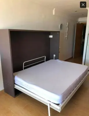 a large bed in a room with a large wall at Vistas espectaculares 