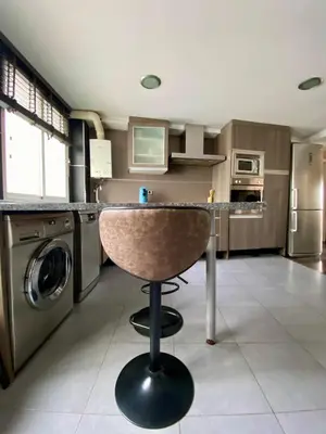 a kitchen with a counter and a washer and dryer at Calm Jungle Apartment Near Valencia in Aldaia