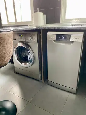 a washing machine and a washer in a kitchen at Calm Jungle Apartment Near Valencia in Aldaia