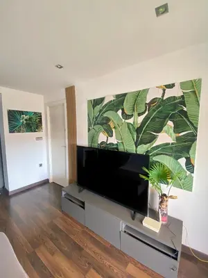a living room with a flat screen tv on a stand at Calm Jungle Apartment Near Valencia in Aldaia