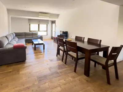 a living room with a table and a couch at Apartamento Los Narcisos 2 in Chulilla