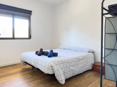 a bedroom with a bed with blue pillows on it at Apartamento Los Narcisos 2 in Chulilla