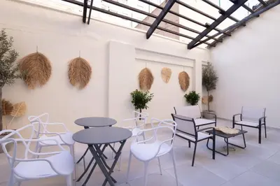 a room with tables and chairs and plants on the wall at Luxury Apartment City Center in Valencia