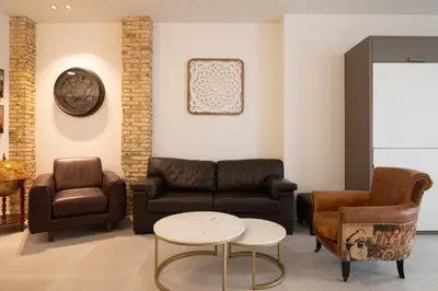 a waiting room with leather furniture and a table at Luxury Apartment City Center in Valencia
