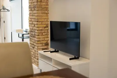 a flat screen tv sitting on a white entertainment center at Luxury Apartment City Center in Valencia