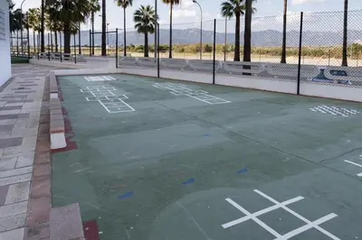 an empty basketball court with palm trees and a fence at EUROMAR, Esc-6, 15-45 in Cullera