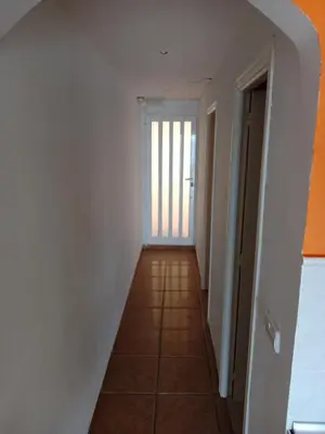a hallway with white walls and a tile floor at HAWAI, Esc-2, 3-10 in Cullera